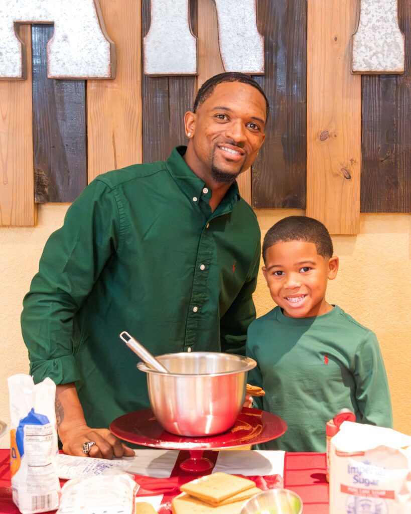 Father and son baking together in matching green shirts