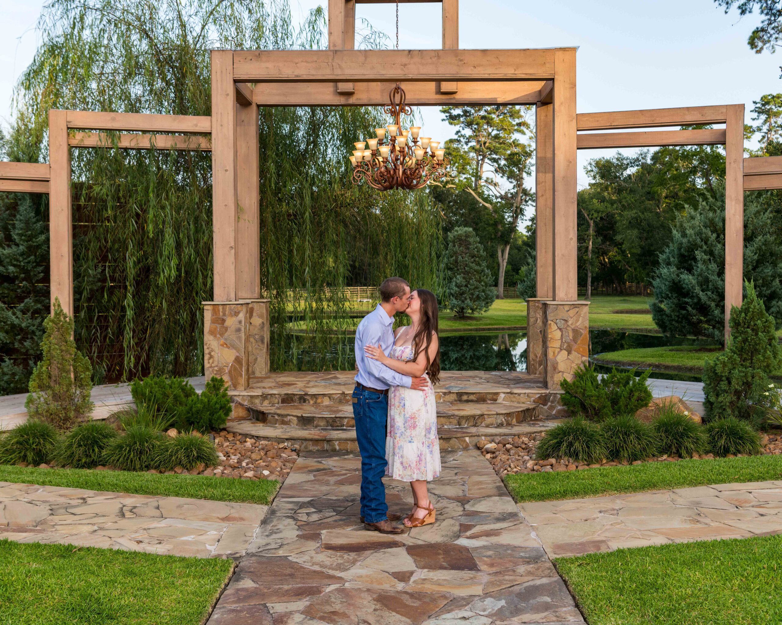 Kiss under the pavilion with chandelier at The Reserve on Cypress Creek in Cypress, Texas.